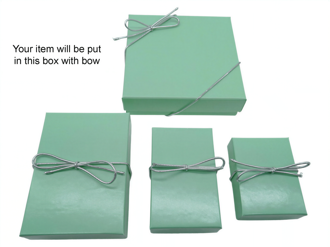 a collection of green gift boxes with silver bows tied around them, indicating that the item will be placed inside one of these boxes.