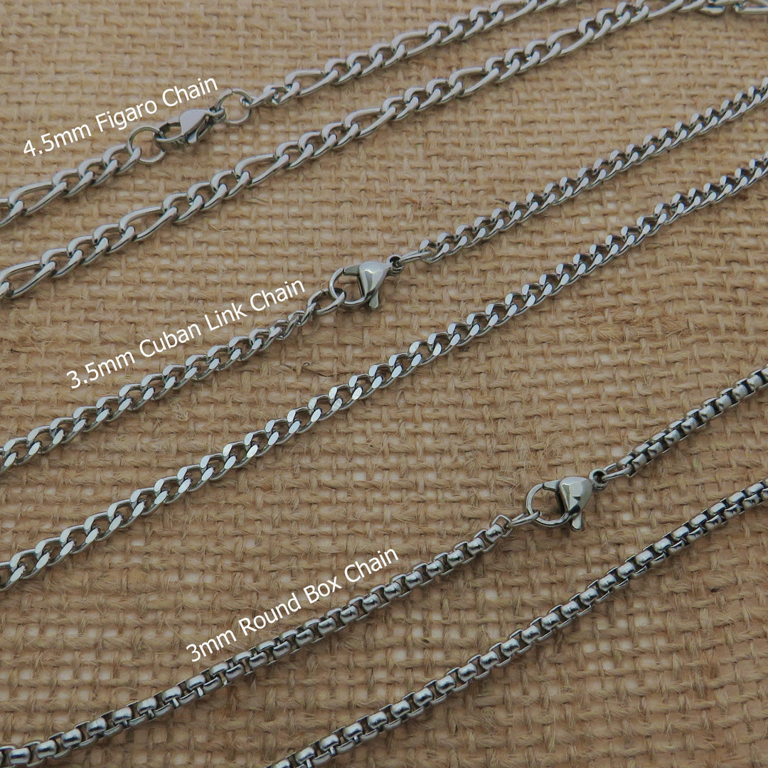 a collection of various metal chains, each with different sizes and designs, arranged on a textured surface.