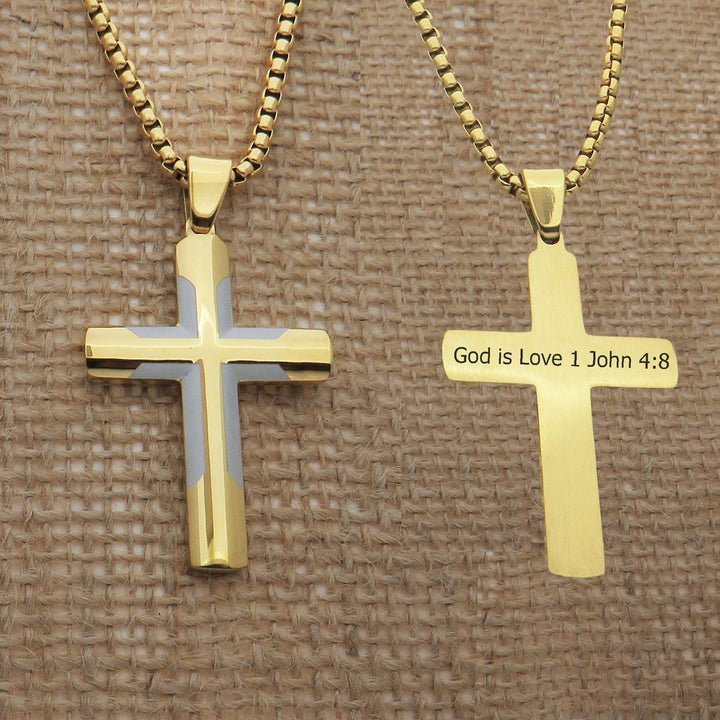 two gold-colored cross necklaces with religious text on them.