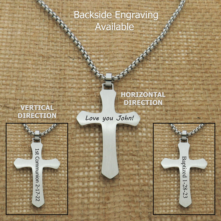 a silver cross pendant with a personalized inscription, displayed on a beige background.