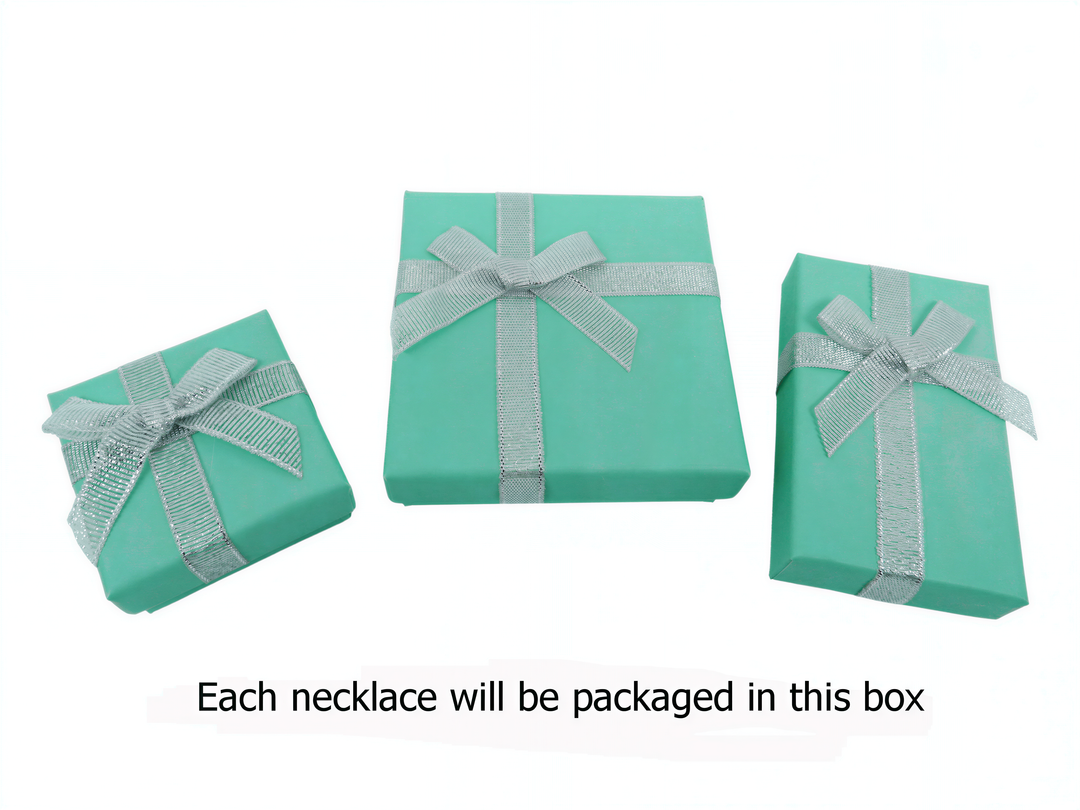 Three turquoise gift boxes with silver ribbons, each containing a necklace.
