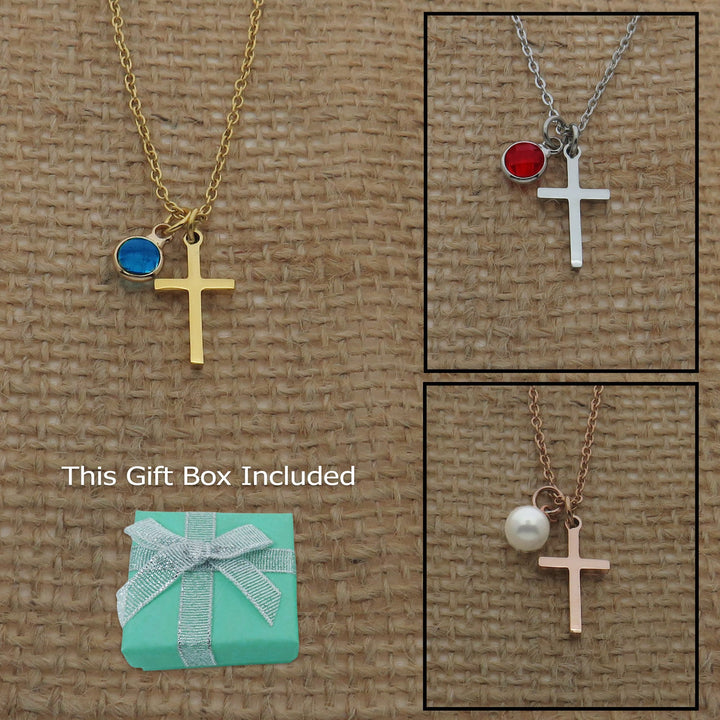 a collection of necklaces and a gift box, all featuring a cross pendant. The necklaces come in various colors and designs, while the gift box is a turquoise-colored box with a bow on top.
