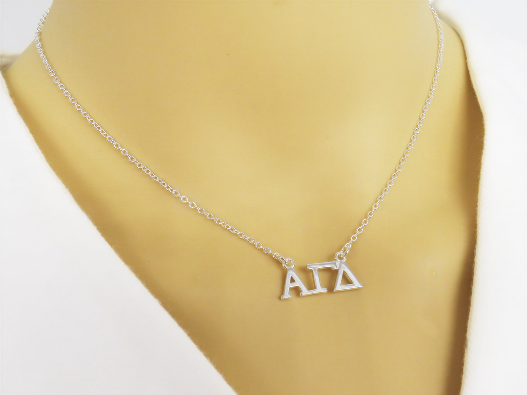 A necklace with the letters "ΑΓΑ" displayed on it.