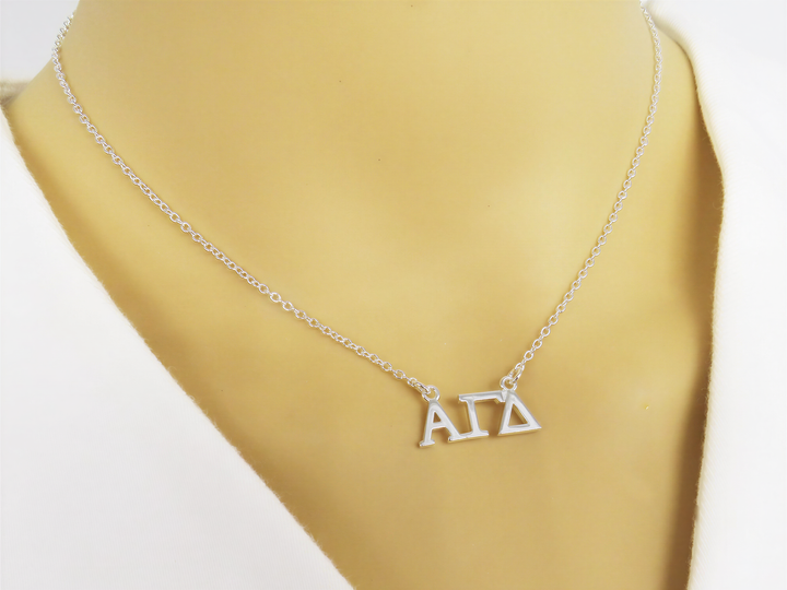 A necklace with the letters "ΑΓΑ" displayed on it.